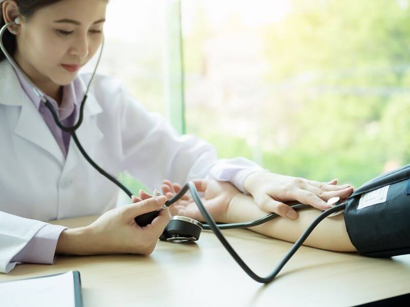 Woman taking blood pressure