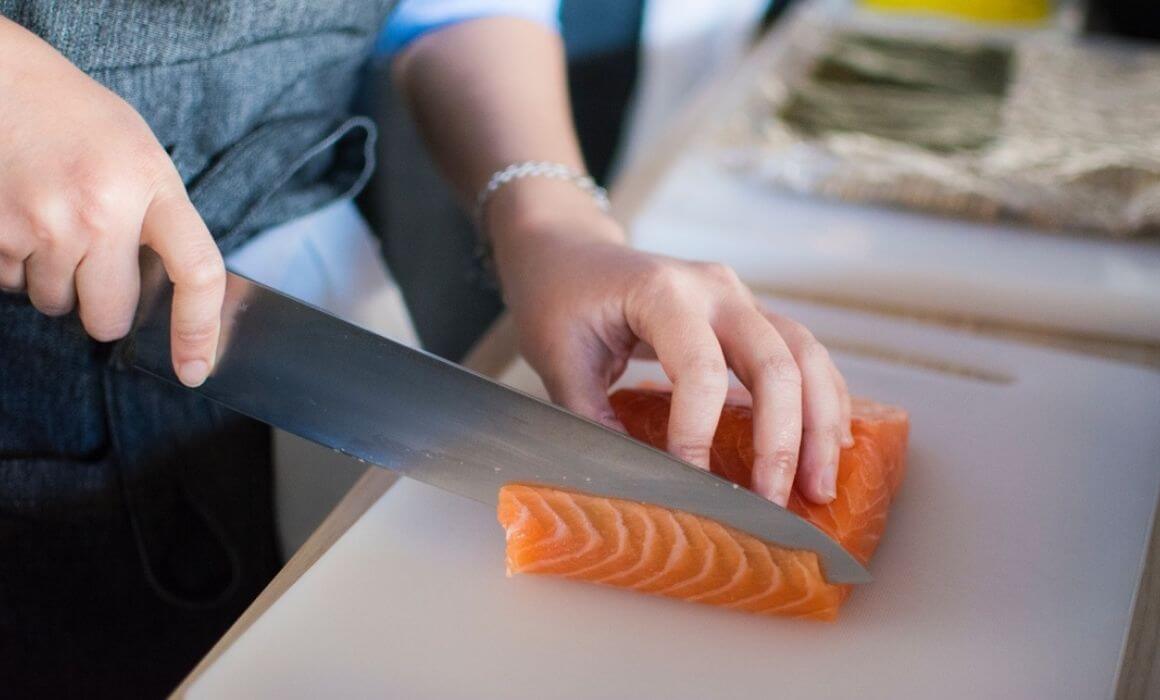 Woman cutting fish