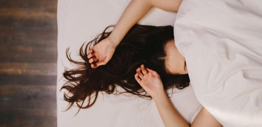 woman sleeping under covers
