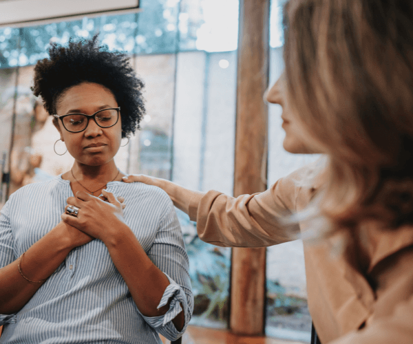 Woman supporting another woman